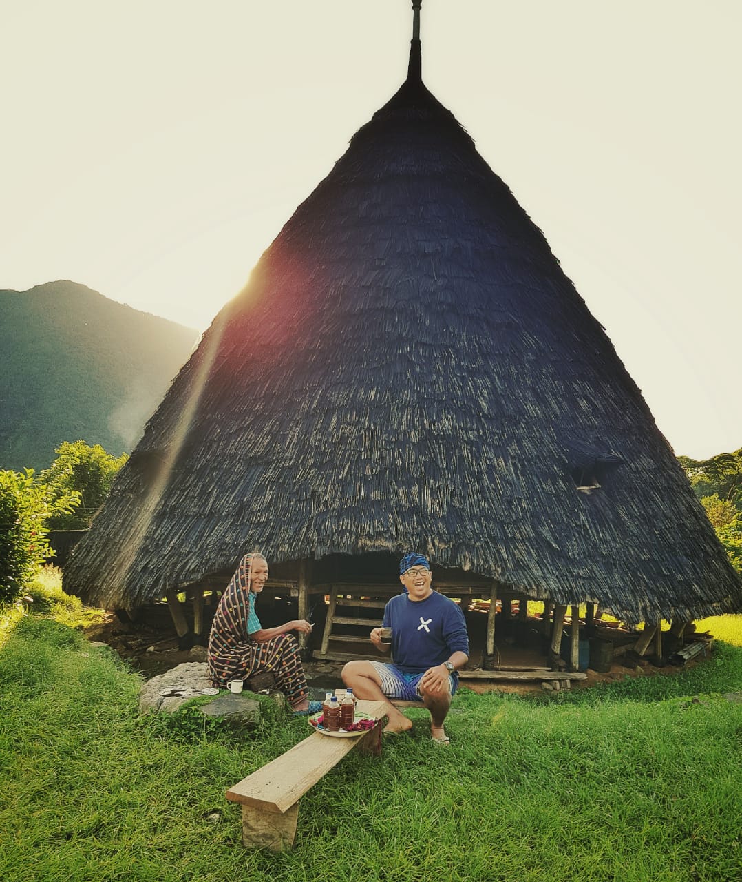 Golden light at Waerebo, local and guest sharing a moment